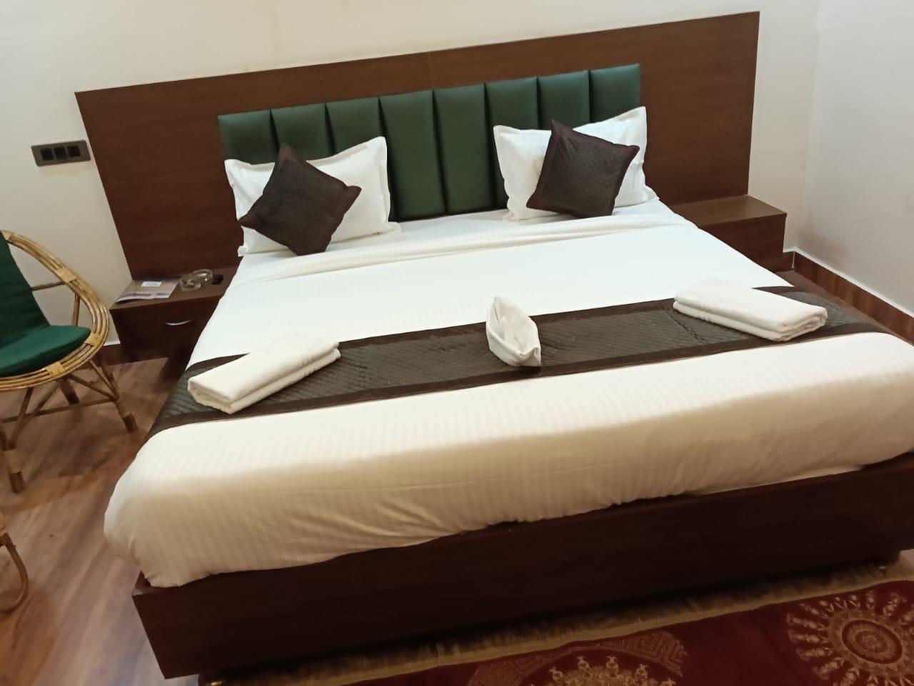 Luxury resort pool with palm trees at sunset